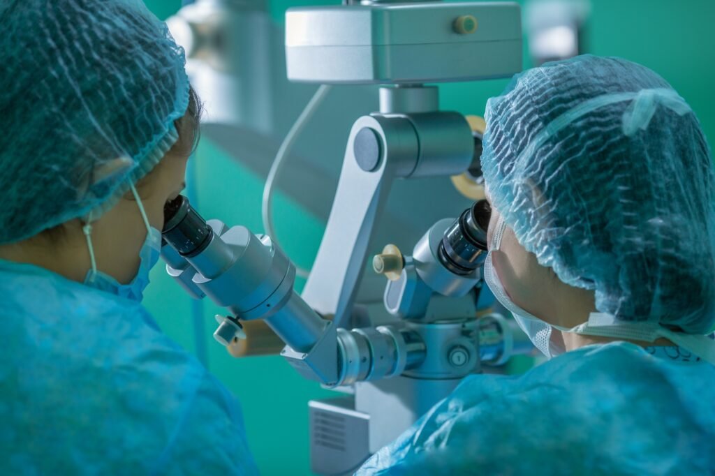 female doctors looking into a microscope. the concept of eye surgery